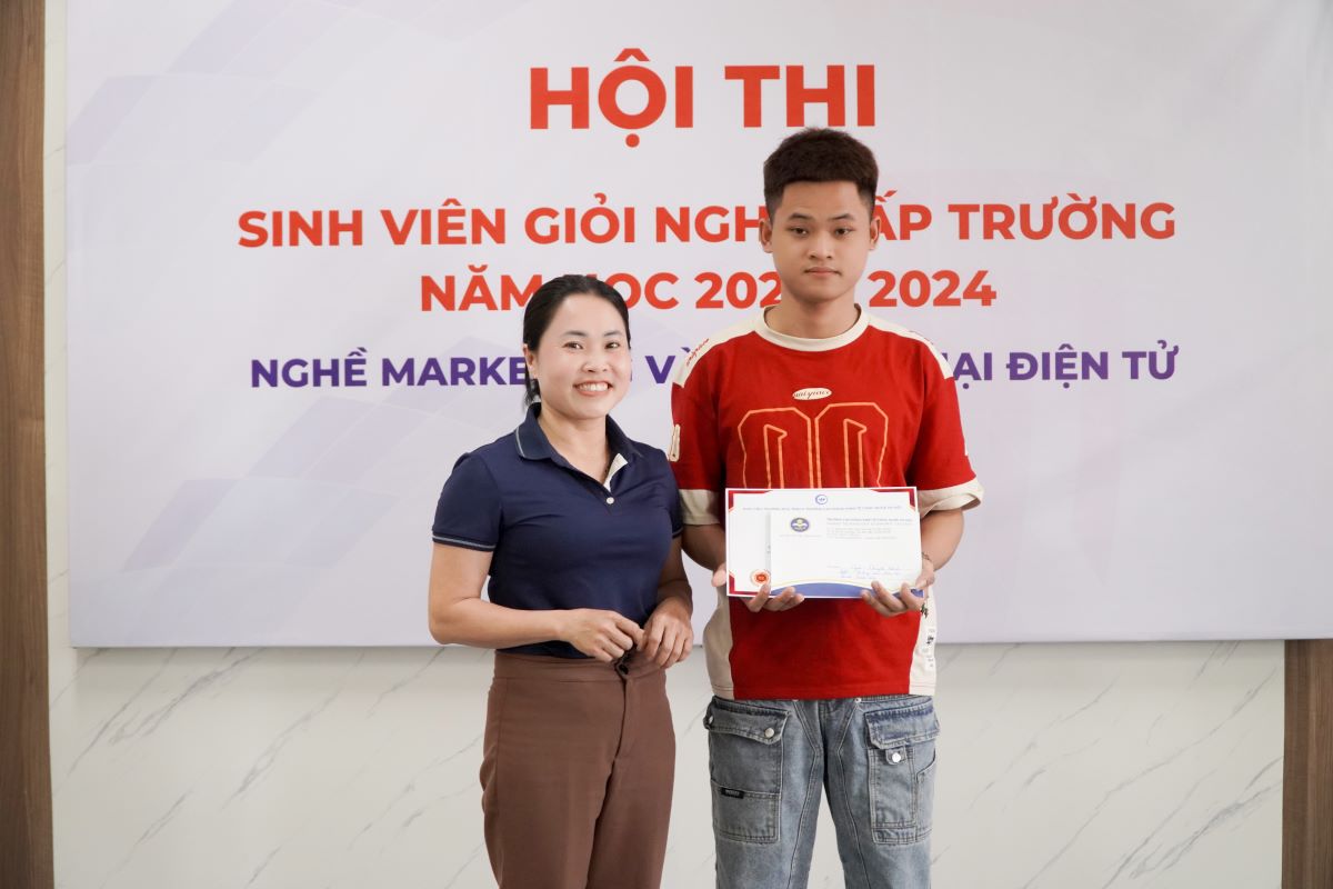 Cô Lại Thị Thúy Minh trao giấy chứng nhận và giải thưởng cho sinh viên đạt giải Khuyến khích nghề Thương mại điện tử