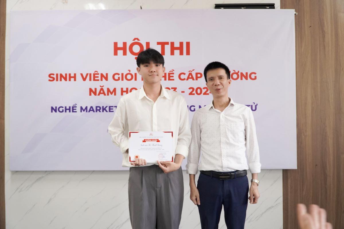 Thầy Nguyễn Văn Trường trao giấy chứng nhận và giải thưởng cho sinh viên đạt giải Nhất nghề Thương mại điện tử